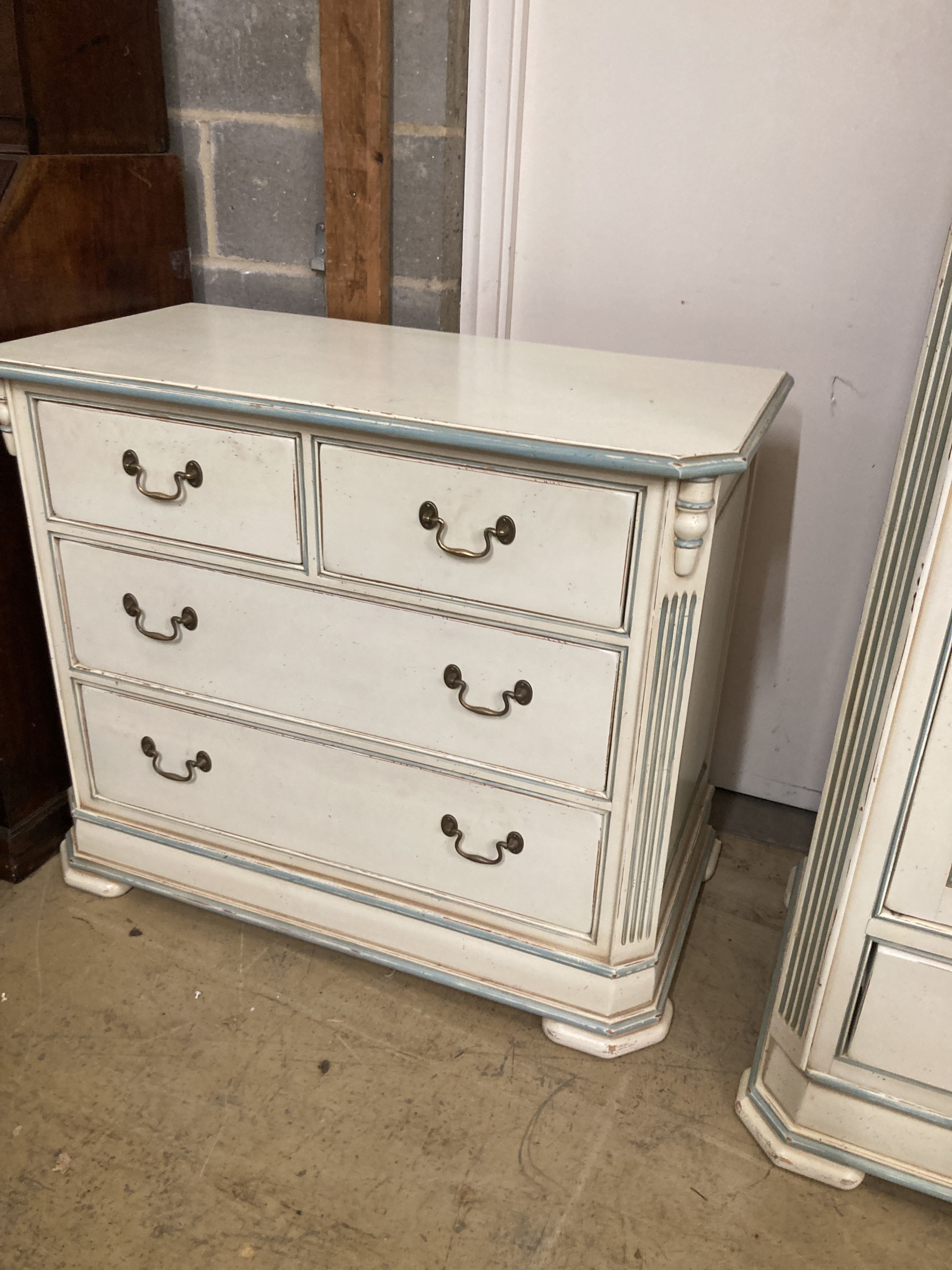 A French provincial style bedroom suite, cream painted, with blue line edging, consisting:- a two door wardrobe, four drawer chest, single bedstead and a tall chest of six drawers, wardrobe W.126cm D.61cm H.202cm